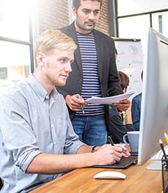 Male designer working at modern office with team.